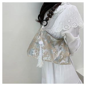 Detail of Chinese jacquard shoulder bag with landscape embroidery and silk tassel