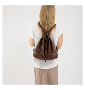 Detailed view of the brown leather drawstring backpack with vintage texture and sleek straps