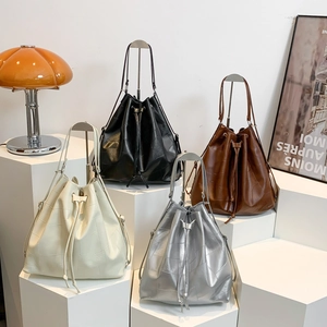 Modern bucket backpack in four colors with patchwork leather and drawstring closure