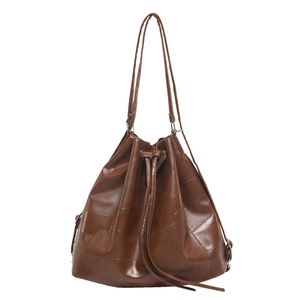 Minimalist brown leather patchwork bucket bag with drawstring and long shoulder straps