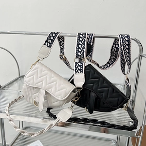 Quilted saddle bags in black and white with V-stitch pattern and wide jacquard straps