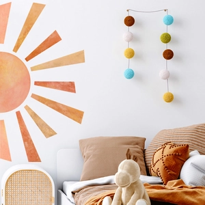 Watercolour sun wall decal for children's room in orange and gold minimalist tones