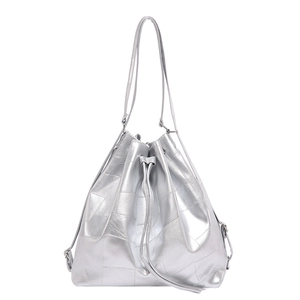 Metallic silver PU leather drawstring bucket bag with geometric patchwork and tassel design