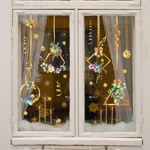 Winter floral window clings with gold stars and snowflakes on a white wooden window