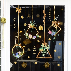 Detail of gold geometric floral window stickers with watercolor plants and stars