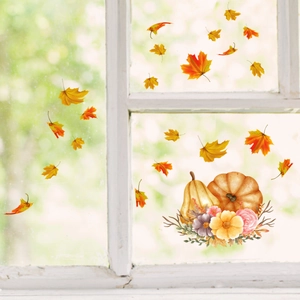 Detailed view of autumn pumpkin and maple leaf static cling stickers on a glass window