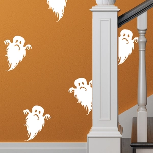 Ghost Halloween wall decals applied on an orange textured wall with staircase decor