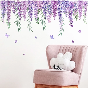Watercolor wisteria wall stickers with butterflies over a pink sofa in a white living room