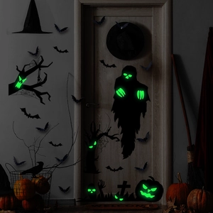 Luminous Halloween wall stickers with glowing ghost and bat patterns on a dark indoor wall