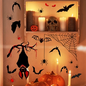 Halloween wall stickers featuring black bats and spider webs in a warm candlelit setting
