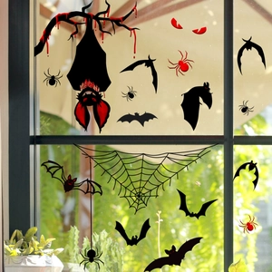 Detail of Halloween window clings featuring black bats, spider webs, and red blood splatters