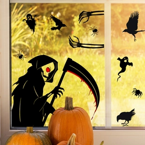 Halloween window stickers showing black ghost and scythe silhouettes on glass