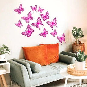 Pink hollow butterfly wall stickers set on light wall in a cozy living room decor