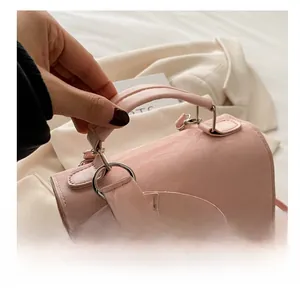 Detailed shot of pink glossy leather handle and metallic rings on a stylish backpack
