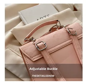 Detail of pink PU leather backpack with adjustable silver buckles and top handle
