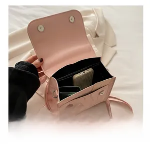 Detail view of pink leather backpack interior with compartments for phone and wallet