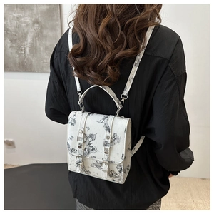 Detailed back view of a mini white PU leather backpack with butterfly and star prints