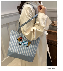 Detail of blue and white striped tote bag with cute 3D cartoon dachshund embroidery