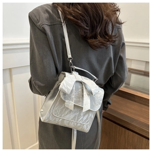 Silver metallic bow backpack on model showing stylish size and fashion texture