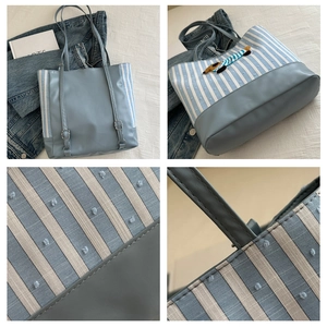 Detail of plaid tote bag with dachshund embroidery, adjustable strap and canvas texture