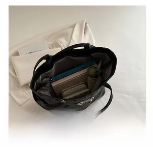 Interior view of large capacity black polka dot tote bag showing daily essentials