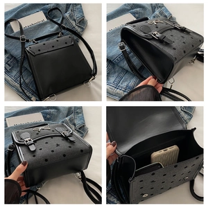 Detail view of retro polka dot backpack showing metal bow buckle and interior capacity