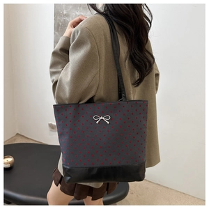 Polka dot canvas tote bag with a silver bow buckle and leather straps for casual wear