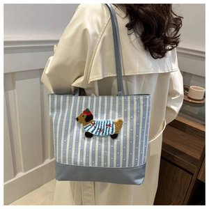 Detail of canvas tote bag with light blue stripes and cute 3D cartoon puppy embroidery