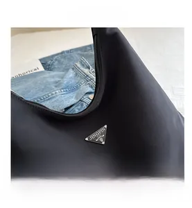 Macro shot of nylon backpack details with silver triangular logo and smooth zipper