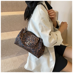 Detail of leopard print handbag with silver T-shaped metal buckle and chain strap