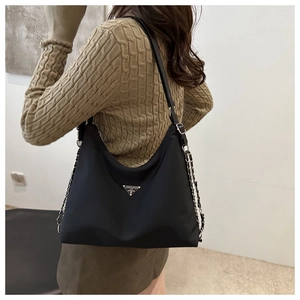 Premium black nylon tote bag with chain strap shown on model for daily commuting