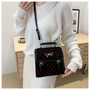 Preppy black handbag with red heart patterns and silver bow detail for women