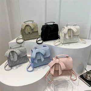Mini butterfly bow backpacks in pastel colors with metallic top handles and marble textures