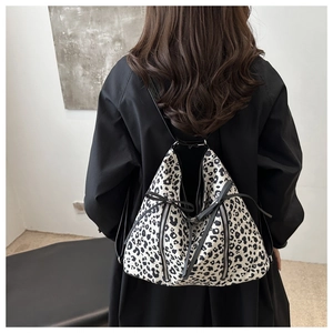 Vista posteriore dello zaino leopardato bianco e nero con cerniera e coulisse decorativa