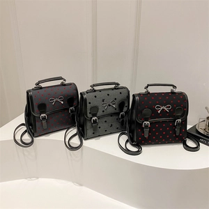 Mini backpacks set with heart and polka dot patterns, featuring silver bow ornaments