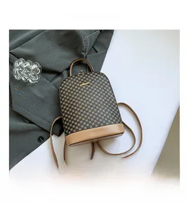 Detailed close-up of retro brown checkered backpack featuring golden metallic logo lettering