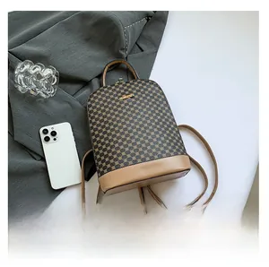 Flat lay of retro brown geometric backpack with leather straps and metal hardware