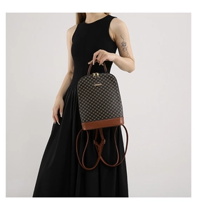 Detailed view of women's checkerboard backpack featuring dual gold zippers and metallic logo