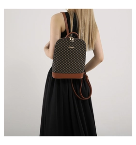 Detail of vintage geometric pattern backpack with gold zippers and leather straps