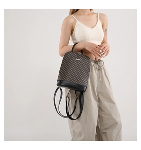 Detail of checkered pattern texture and metal brand logo on stylish brown backpack