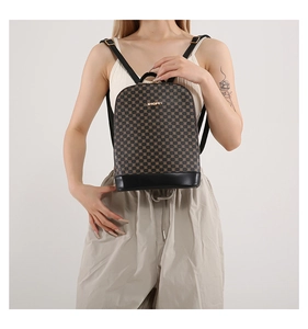 Close-up of a women's vintage floral pattern backpack with gold logo and leather trim