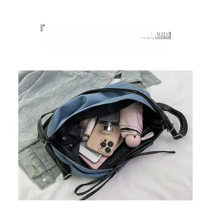 Detail of spacious denim tote interior showing large capacity for daily essentials