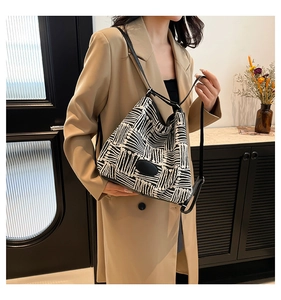 Détail d'un sac cabas géométrique noir et blanc porté par un mannequin pour le style