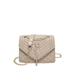 Quilted apricot crossbody bag with gold SOS logo and chain strap on white background