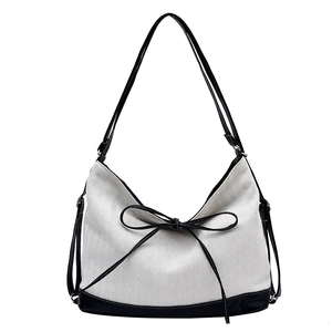 Classic black and white chevron tote bag with leather straps and bow accent for women