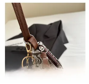 Detail of premium plaid canvas bag featuring smooth zipper and golden metal hardware hooks
