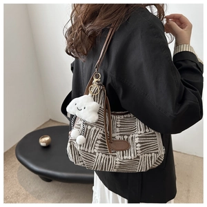 Detail of canvas bag featuring geometric wave patterns and a cute cloud plush charm