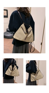Detail of khaki nylon tote bag featuring brown leather trim and gold metal hardware