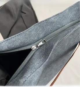 Detail of smooth silver zipper and durable gray fabric on large commuter tote bag