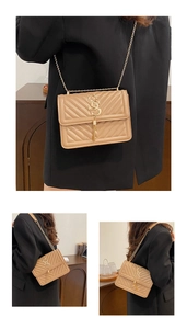 Detailed view of beige quilted crossbody bag with gold chain strap and tassel charm